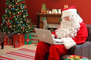Santa Claus working on laptop computer